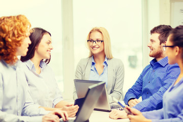 smiling team with laptop and table pc computers