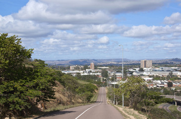 Empty Asphalt  Road Leading into Industrial Landscape