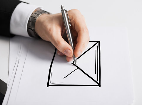 close up of male hand with pen drawing graph