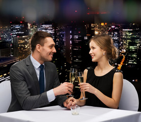 couple with glasses of champagne at restaurant