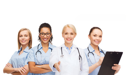 Fototapeta premium smiling female doctor and nurses with stethoscope