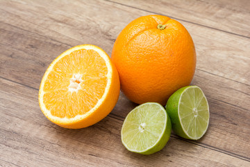 Fototapeta na wymiar Orange And Lime Citrus Fruits On Wood Table