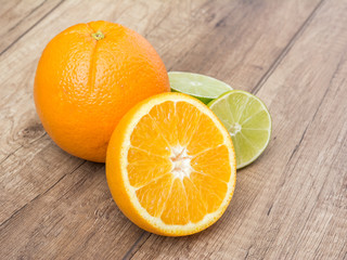 Orange And Lime Citrus Fruits On Wood Table