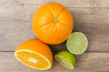 Orange And Lime Citrus Fruits On Wood Table