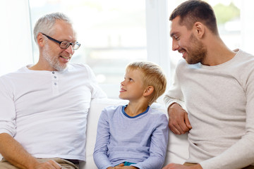 smiling family sitting on couch home