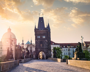 Fototapeta na wymiar Charles bridge tower in Prague on sunrise