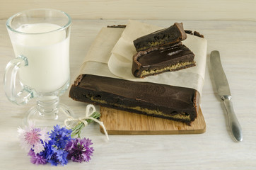 Chocolate tart with halva  near cup of milk