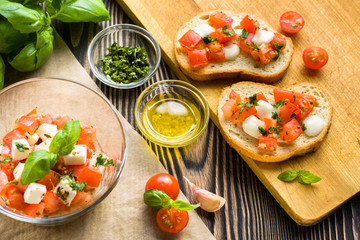 Bruschetta with roasted tomatoes, mozzarella cheese, garlic and