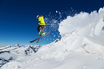 Alpine skier jumping from hill - obrazy, fototapety, plakaty