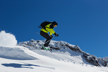 Fototapeta na wymiar Alpine skier jumping from hill