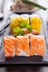 Sushi pieces on black stone