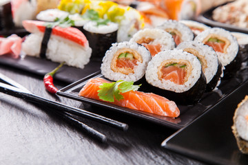 Sushi pieces on black stone