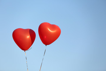 Fototapeta na wymiar Love heart balloons on sky background