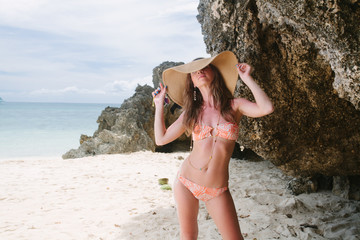 Beautiful woman posing on a paradise beach