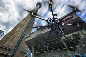 Flying drone with downtown in the background
