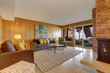 Basement living room with fireplace and walkout patio
