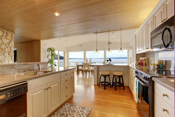 Kitchen area with paneled ceiling and hardwood floor