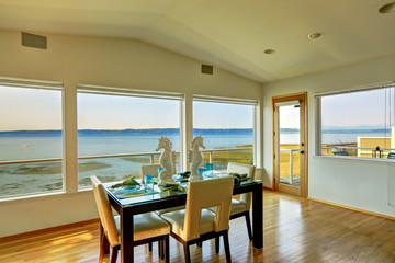 Luxury house interior. Bright elegant dining area with scenic ba