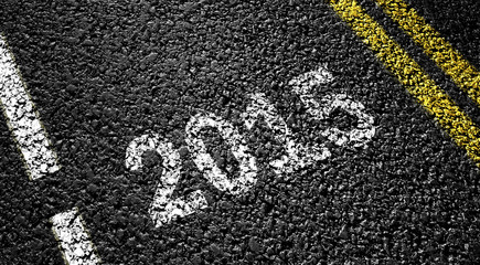 Obraz premium 2015 year on the asphalt road