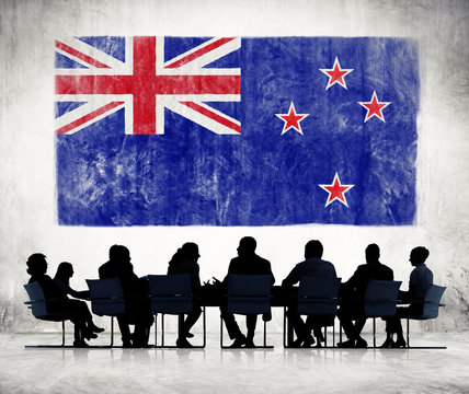 Business People And A Flag Of New Zealand