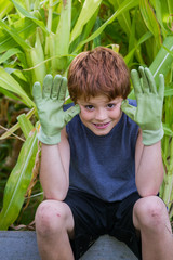 young boy with green gloves