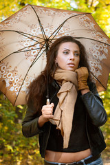 Brunette stands with an umbrella in his hand