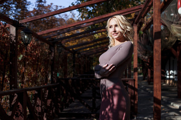 beautiful blonde in dress walks in autumn