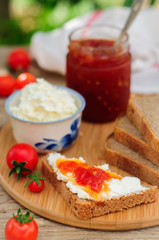 Slices of Brown Bread with Cream Cheese and Tomato and Chili Jam