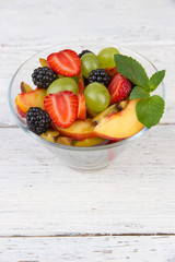 fresh tasty fruit salad on wooden table