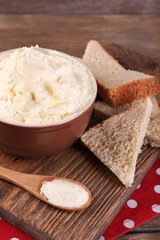 Fototapeta na wymiar Fresh homemade butter in bowl and sliced bread,