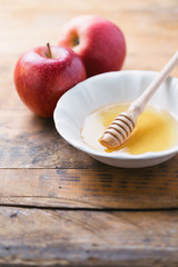 Acacia Honey and apples on wooden table