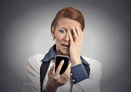 stressed woman shocked with message on smartphone