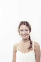 Fototapeta premium Portrait of beautiful young woman in white, smiling