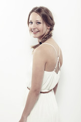 Naklejka premium Portrait of beautiful young woman in white, smiling