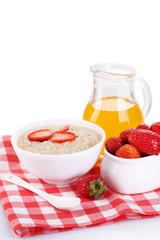 Tasty oatmeal with berries and juice isolated on white