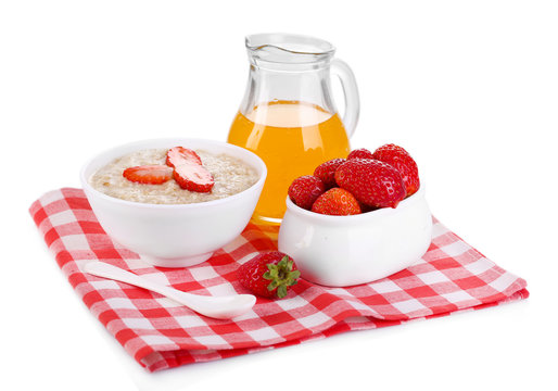 Tasty oatmeal with berries and juice isolated on white