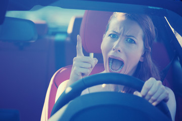 angry aggressive woman driving car screaming 