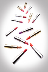 Different-colored lipsticks on white background