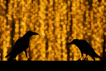 Silhouette crow with festive blur bokeh elegant abstract backgro