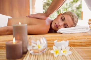 Obraz na płótnie Canvas Woman receiving back massage at spa center