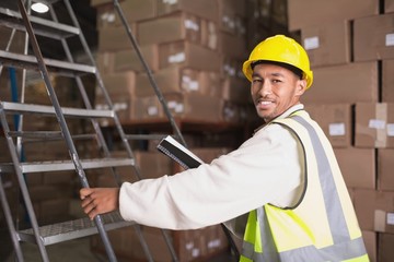 Worker with diary in warehouse