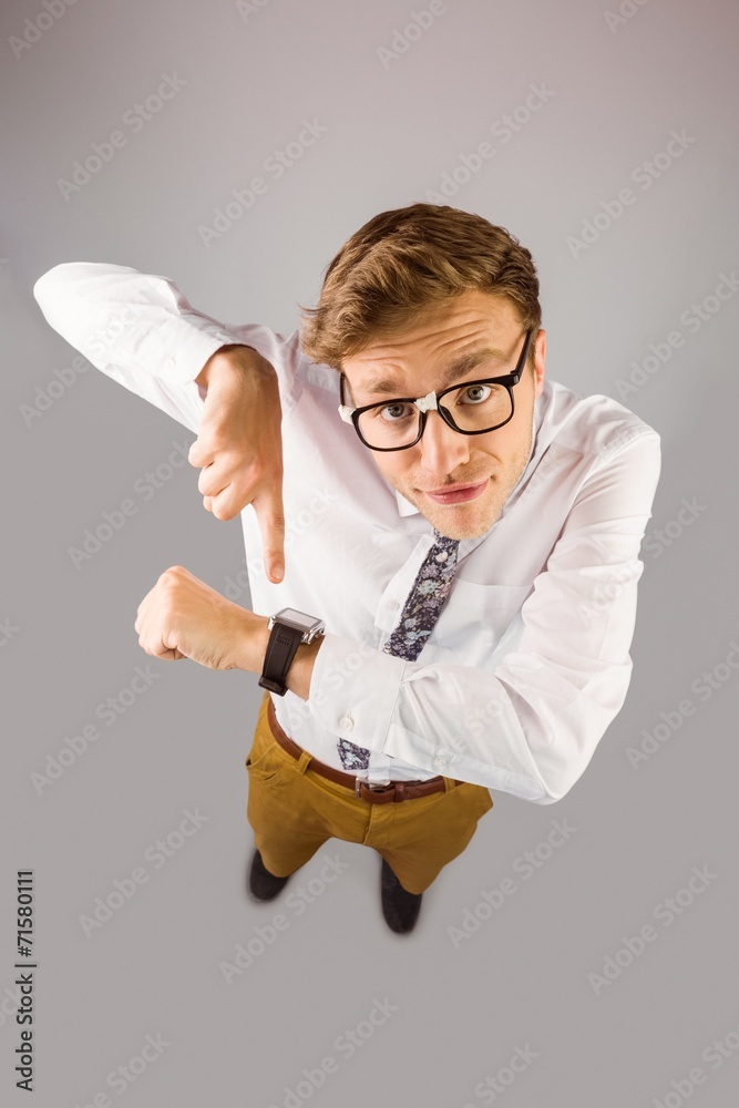 Poster geeky businessman pointing to watch