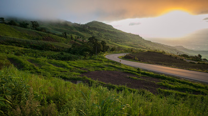 Road on mountain and sun