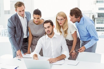 Business people using laptop at office