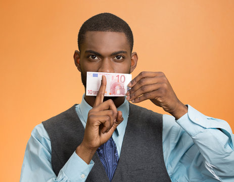 Headshot bribery man money cover mouth on orange background