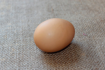 an egg of hen on the sacking background