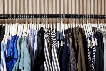 Clothes in a row on coat hangers, close up