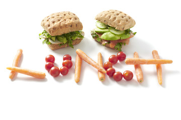 Healthy lunch spelled out with carrots and tomatoes