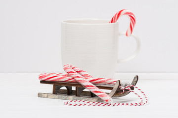 Christmas Candy Cane On Wooden Sledge. White Painted Wood Backgr