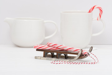 Christmas Candy Cane On Wooden Sledge. White Painted Wood Backgr